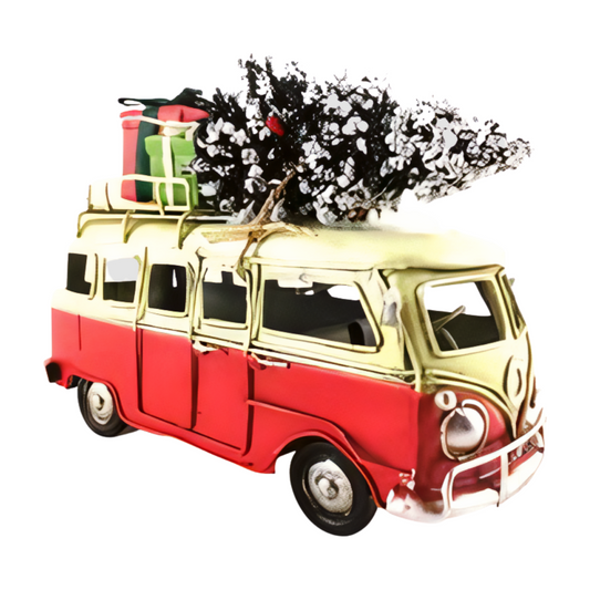 Red and cream vintage-style metal combi van with a snow-covered Christmas tree and wrapped presents on the roof