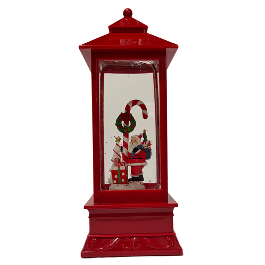 Red Christmas lantern snow globe featuring Santa holding a candy cane with swirling glitter.