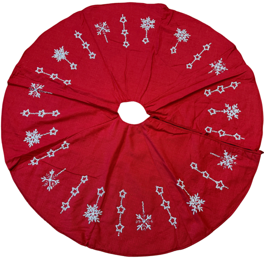 Hand-beaded red cotton Christmas tree skirt with white star and snowflake designs