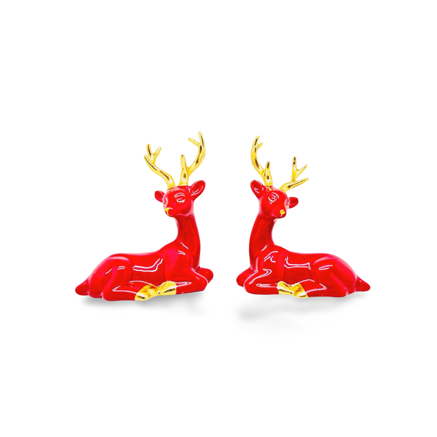 Glossy red ceramic reindeer figurines in a reclining pose with gold antlers, hooves, and noses.