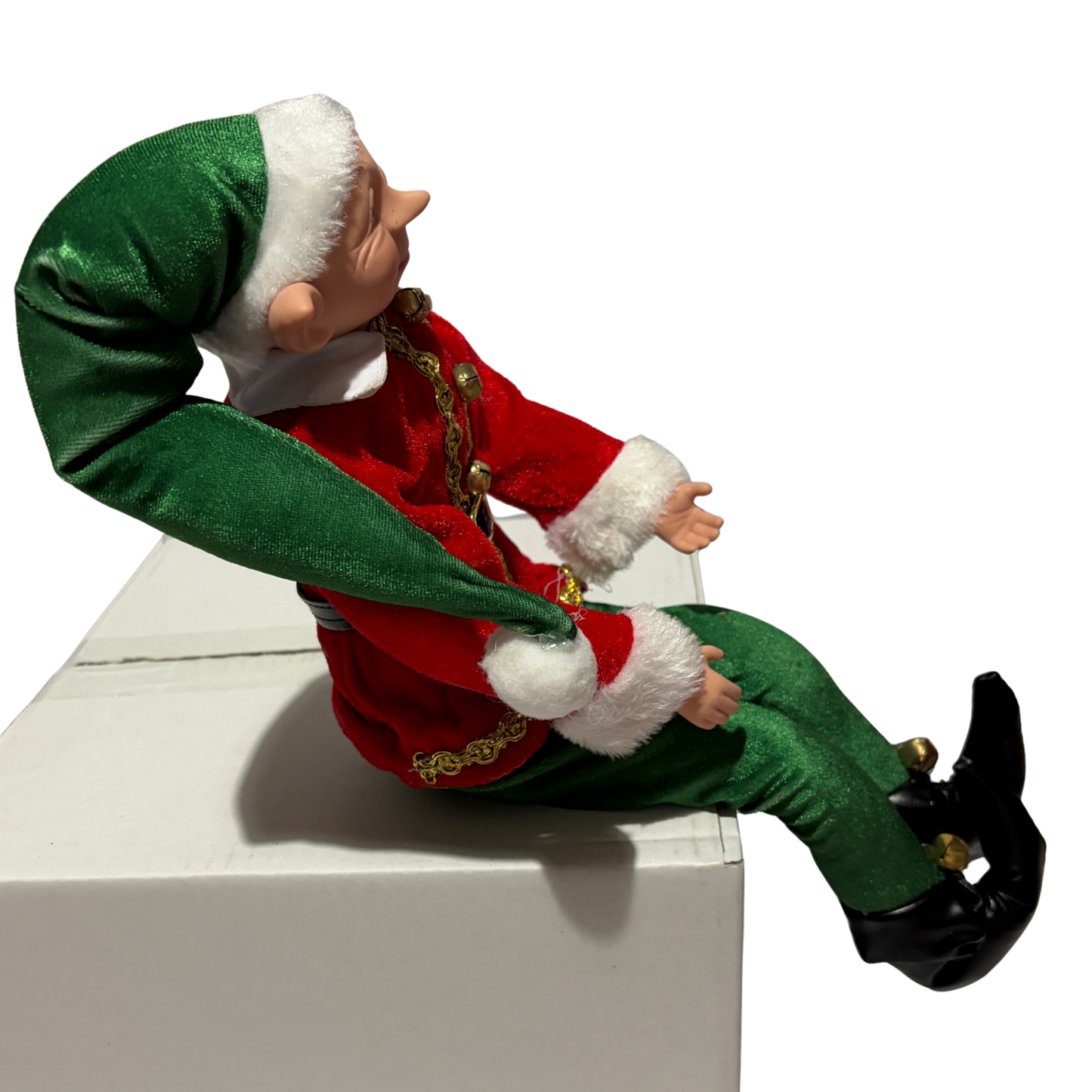 Sitting Christmas elf in red jacket and green trousers with a green hat and black boots
