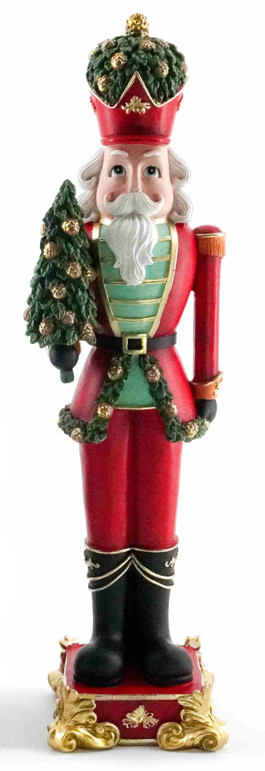 Regal red and green nutcracker figurine holding a Christmas tree