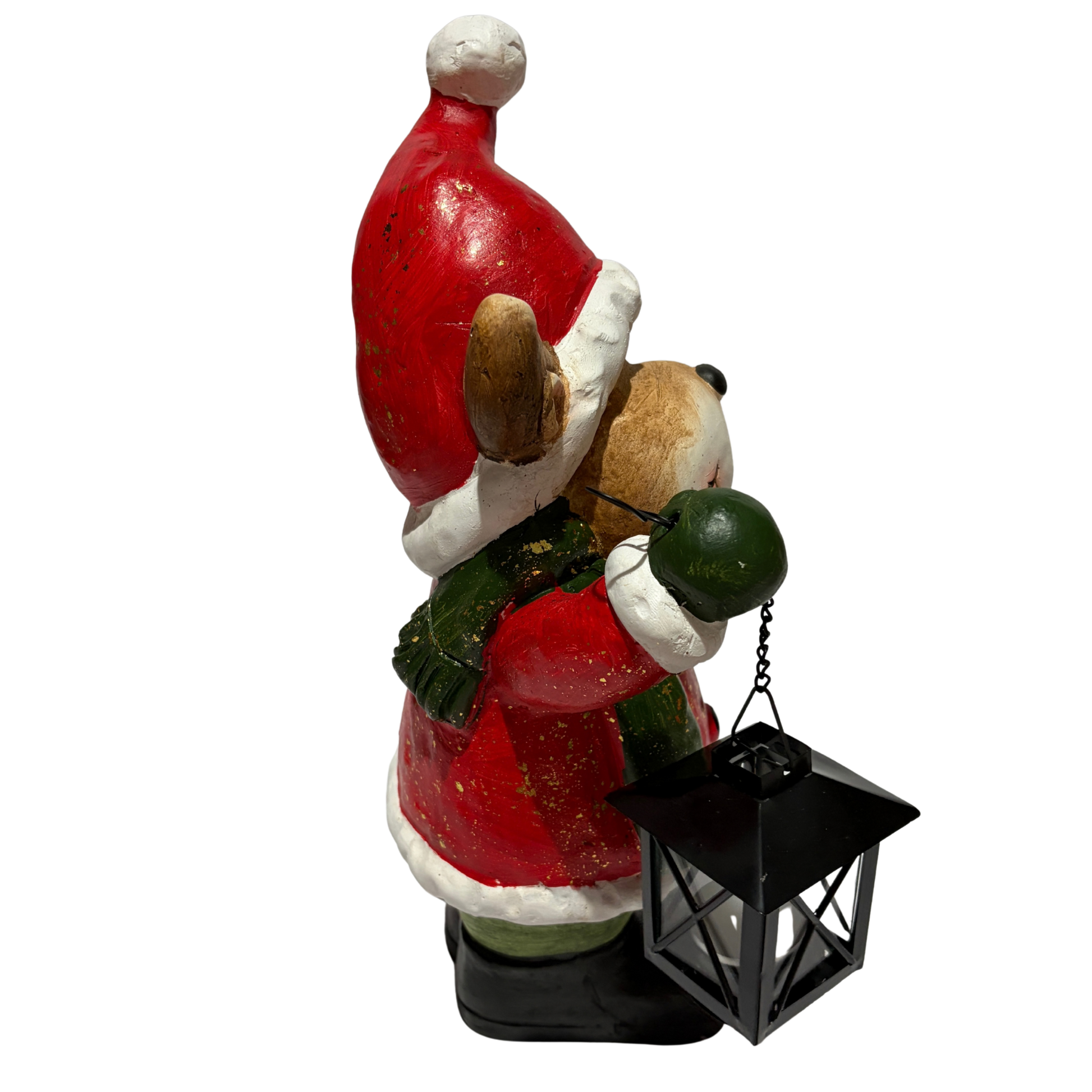 Smiling reindeer figurine wearing a red Santa outfit and green scarf, holding a lantern and a wrapped gift