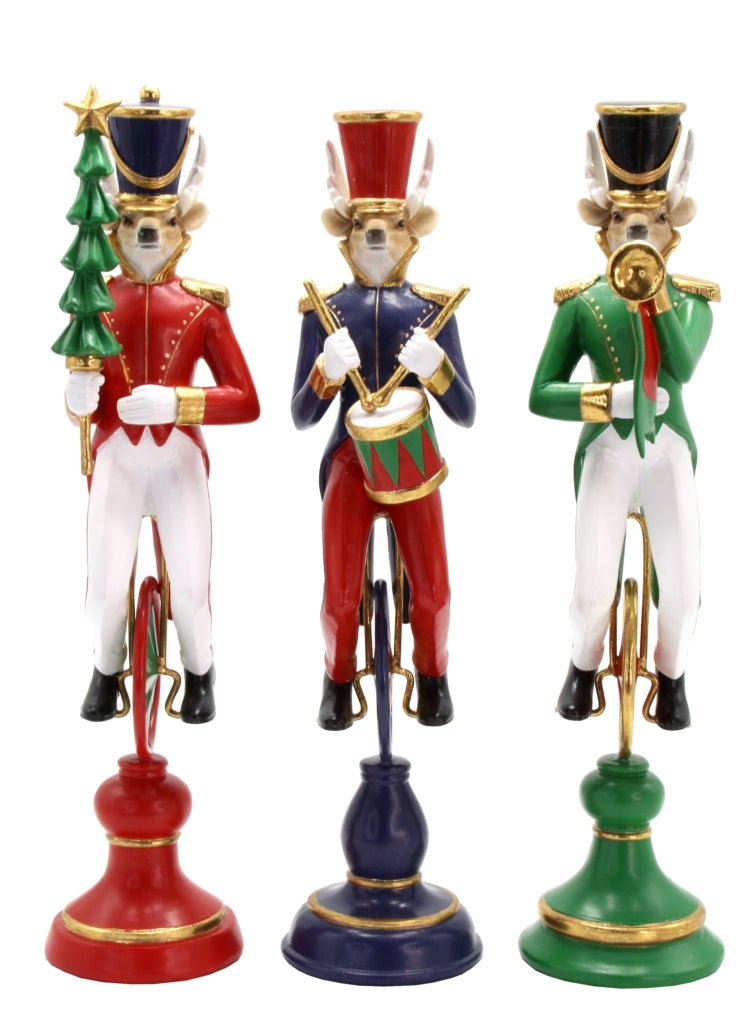 Reindeer nutcracker figurine in green coat playing a trumpet on a decorative stand