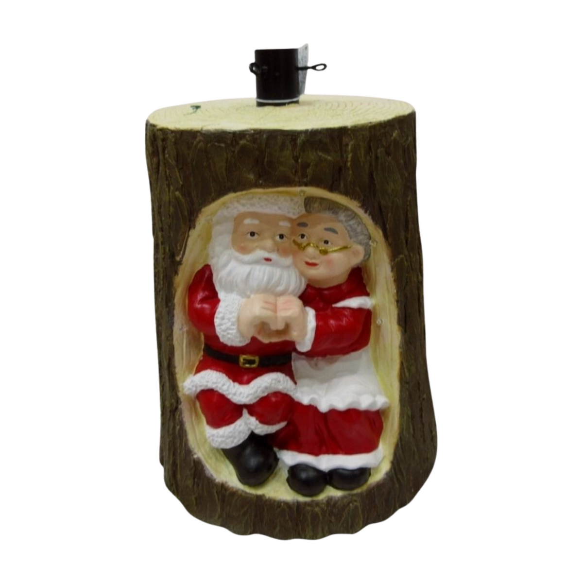Tree holder shaped like a log with Santa and Mrs. Claus figurines inside, dressed in red and white outfits, designed to hold a Christmas tree