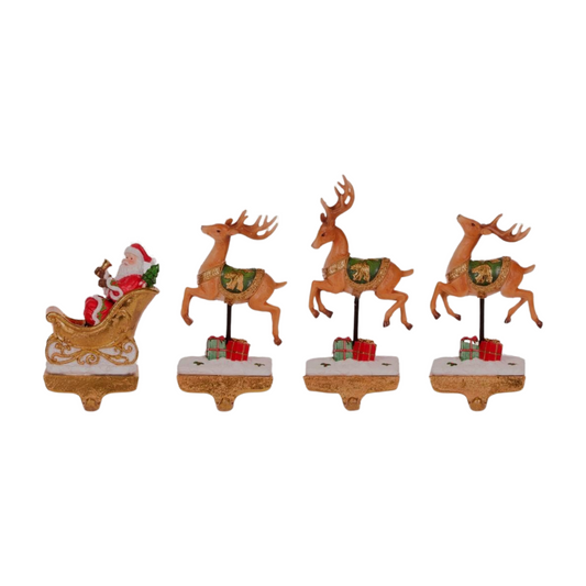 Set of four stocking hangers featuring Santa in a golden sleigh and three reindeer with green saddles and red gift boxes