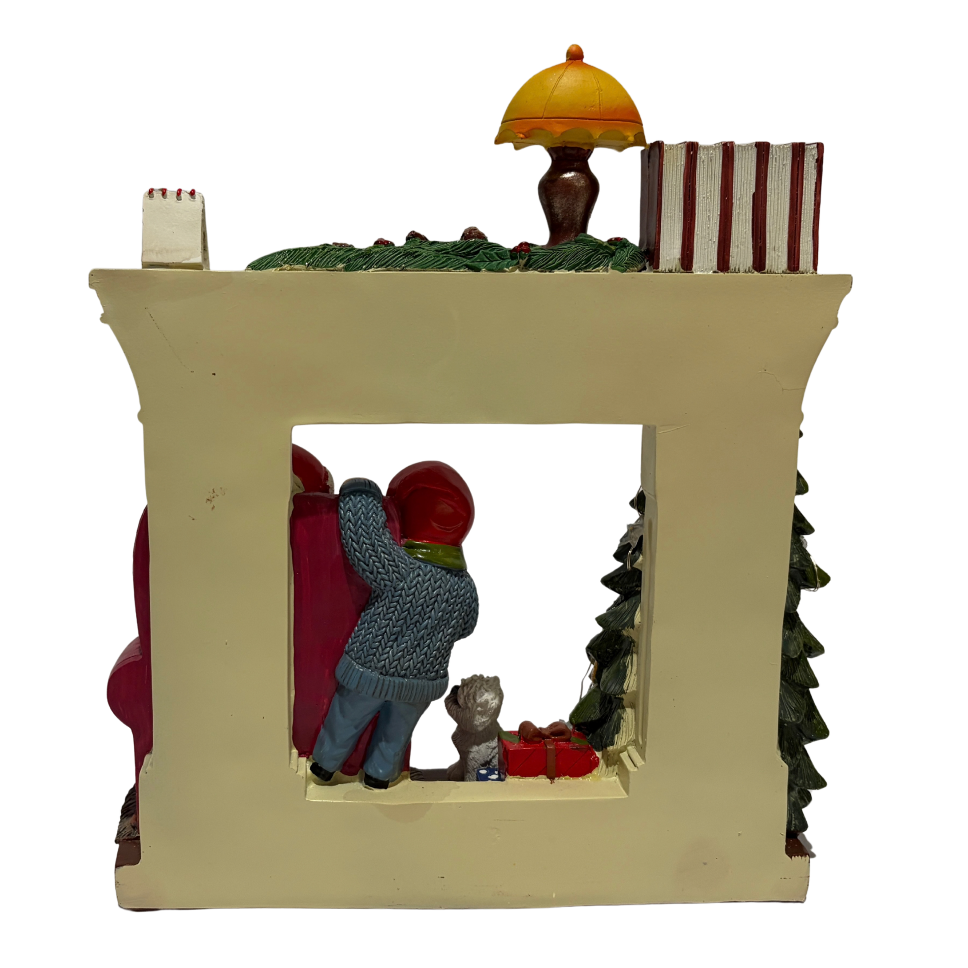  Santa sitting in an armchair beside a Christmas tree and fireplace with a child and dog nearby