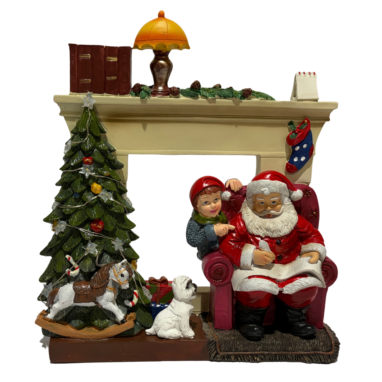  Santa sitting in an armchair beside a Christmas tree and fireplace with a child and dog nearby