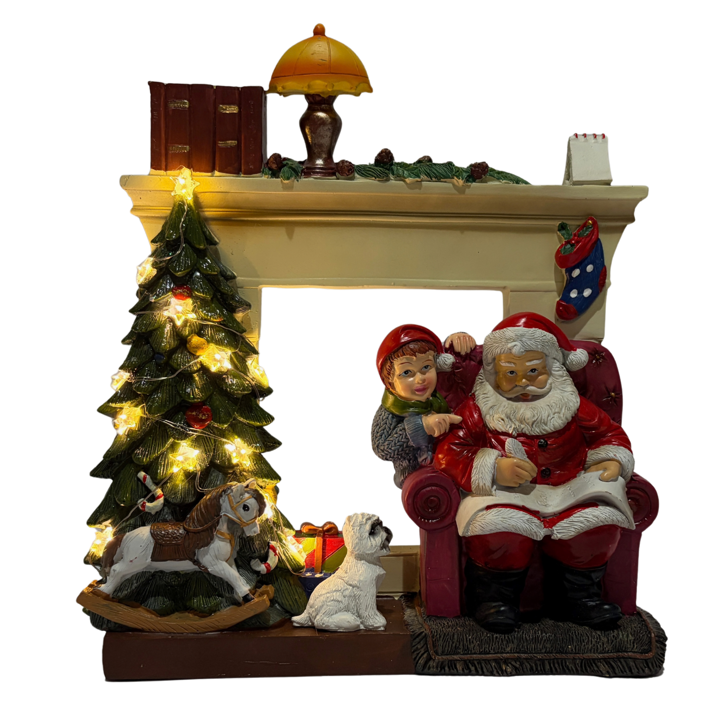  Santa sitting in an armchair beside a Christmas tree and fireplace with a child and dog nearby