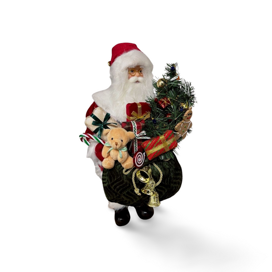Santa Claus figurine holding a green velvet sack filled with presents, a teddy bear, a decorated Christmas tree, candy cane, and gold bells.