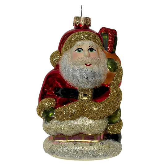 Decorative Christmas ornament of a glittery Santa Claus figure on a white background