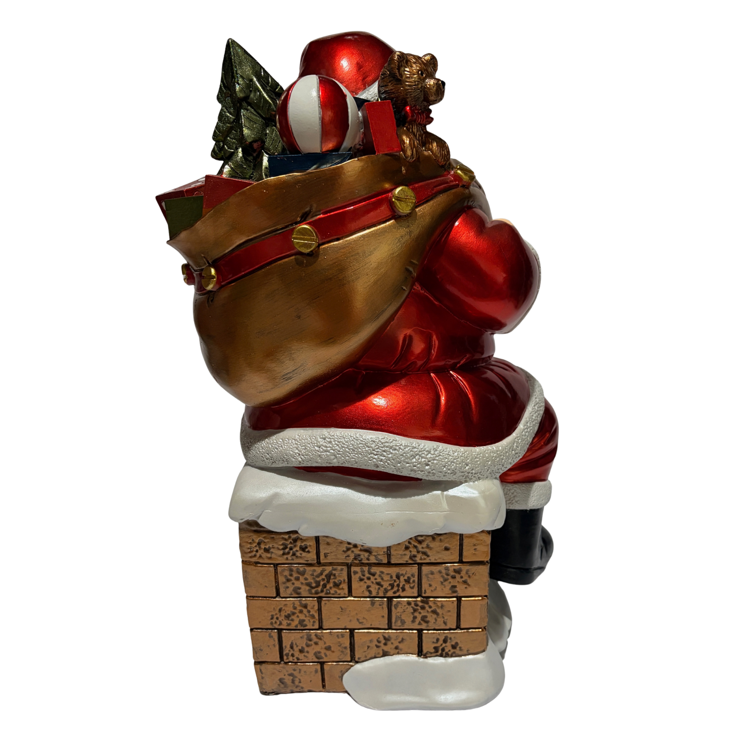 Santa ornament sitting on a snow-covered chimney holding a sack of toys