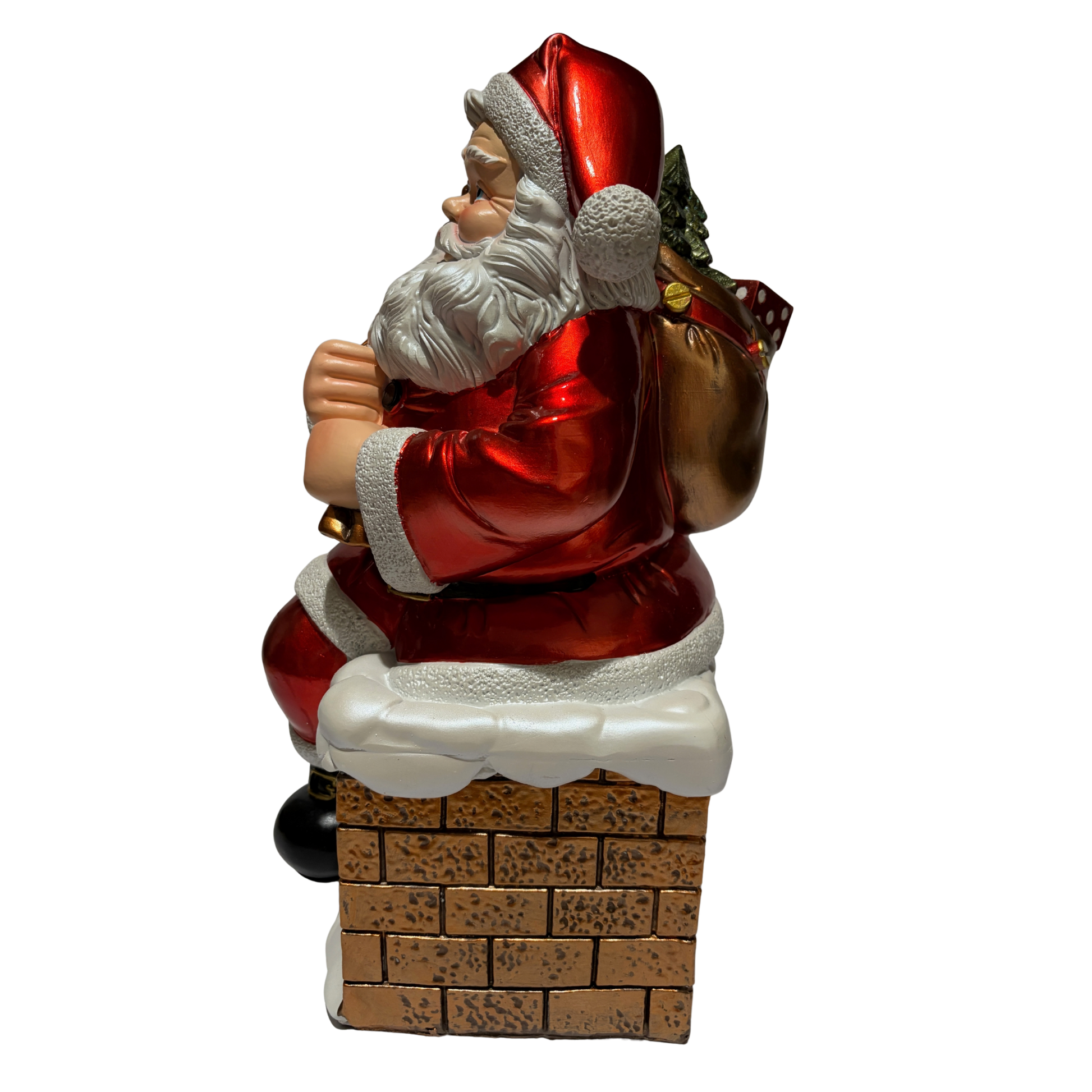 Santa ornament sitting on a snow-covered chimney holding a sack of toys