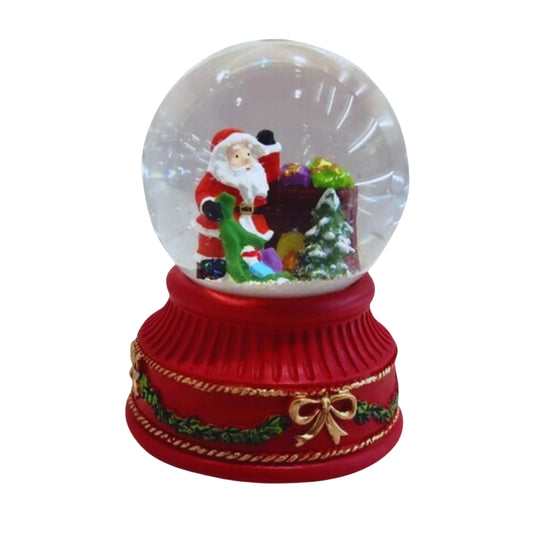 Santa snow globe with gift sack and Christmas tree on red base with gold bow and holly detail
