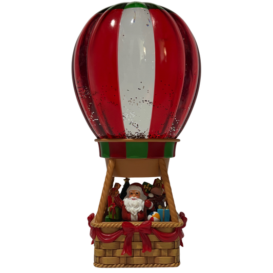 Light up Santa hot air balloon snow globe with red, green, and white balloon and glitter effect