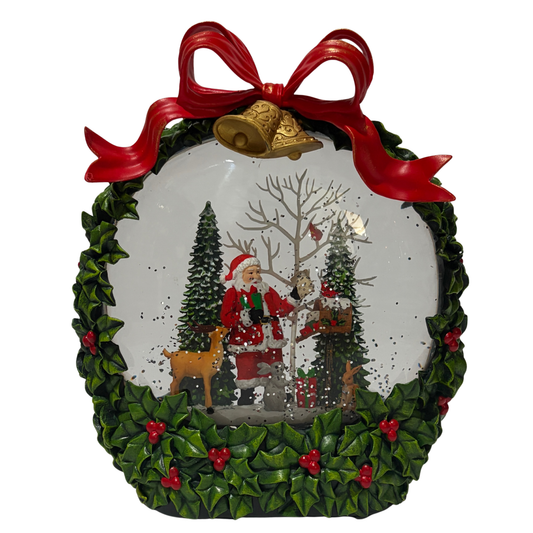 Santa in wreath snow globe decoration with holly leaves, red bow, and woodland scene snow globe.