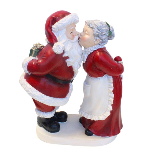 Santa and Mrs Claus kissing figurine with Santa holding a gift and Mrs Claus in a red dress and apron