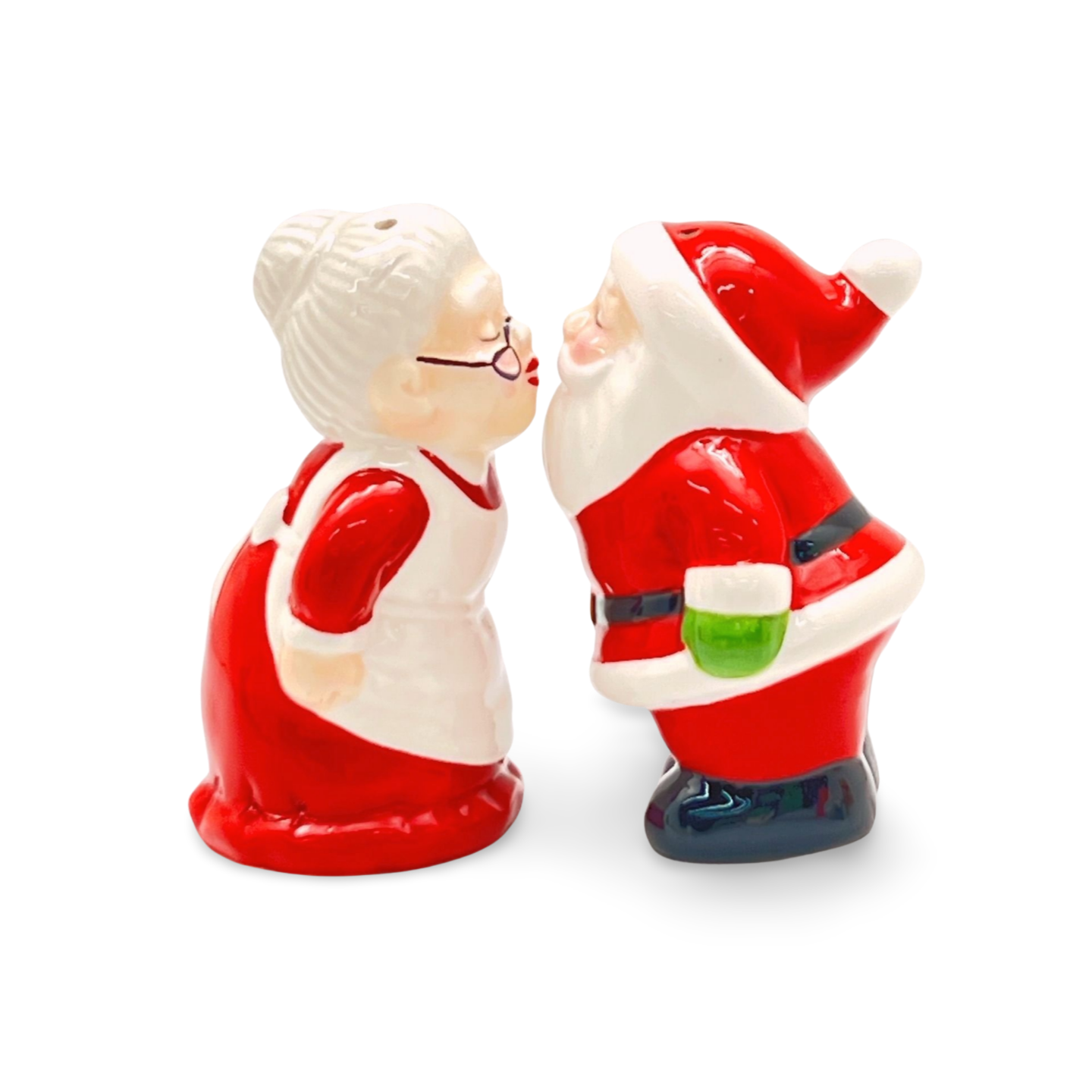 Ceramic salt and pepper shakers shaped like Santa and Mrs. Claus leaning in for a kiss, both in red and white outfits.