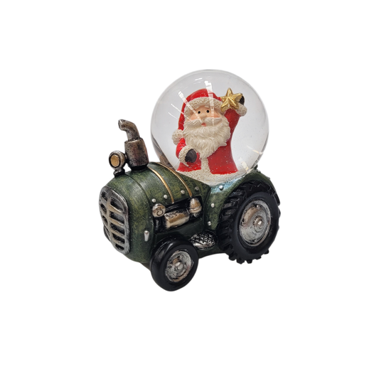 Snow globe with Santa holding a gold star mounted on a green vintage tractor base