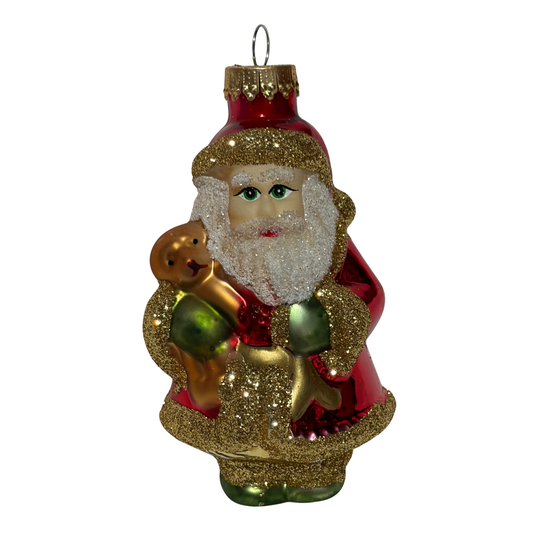 Decorative glass ornament of a Santa Claus figure holding a teddy bear on a white background