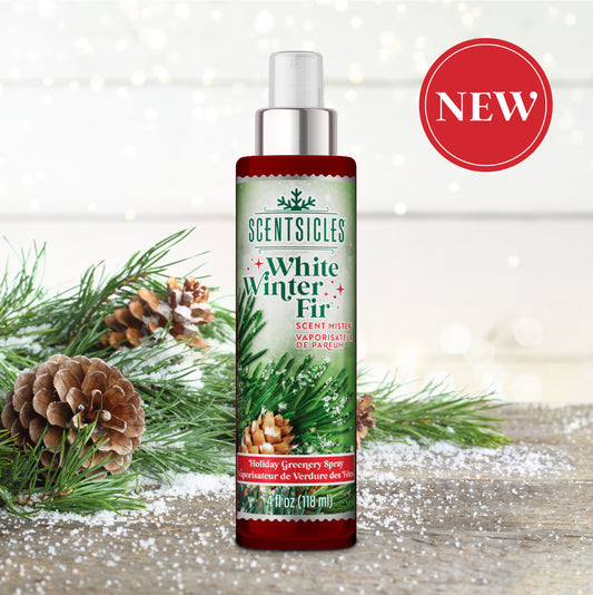 Scentsicles White Winter Fir mist bottle with pinecones and greenery on a wooden surface.