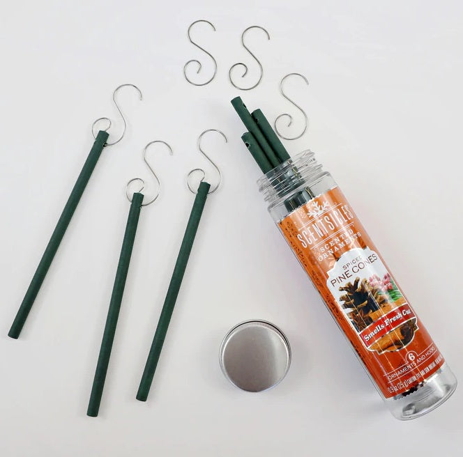 Set of decorative sticks with a canister labeled 'Pinecones' on a white background