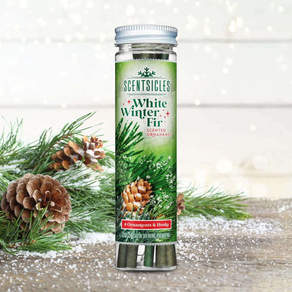 Scentsicles White Winter Fir scented ornament packaging with Christmas decorations on a wooden surface.