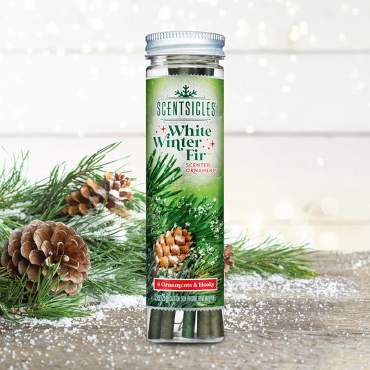 Scentsicles White Winter Fir scented ornament packaging with Christmas decorations on a wooden surface.