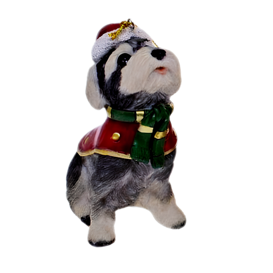 Sitting schnauzer dog ornament wearing a red coat, green scarf and white winter hat