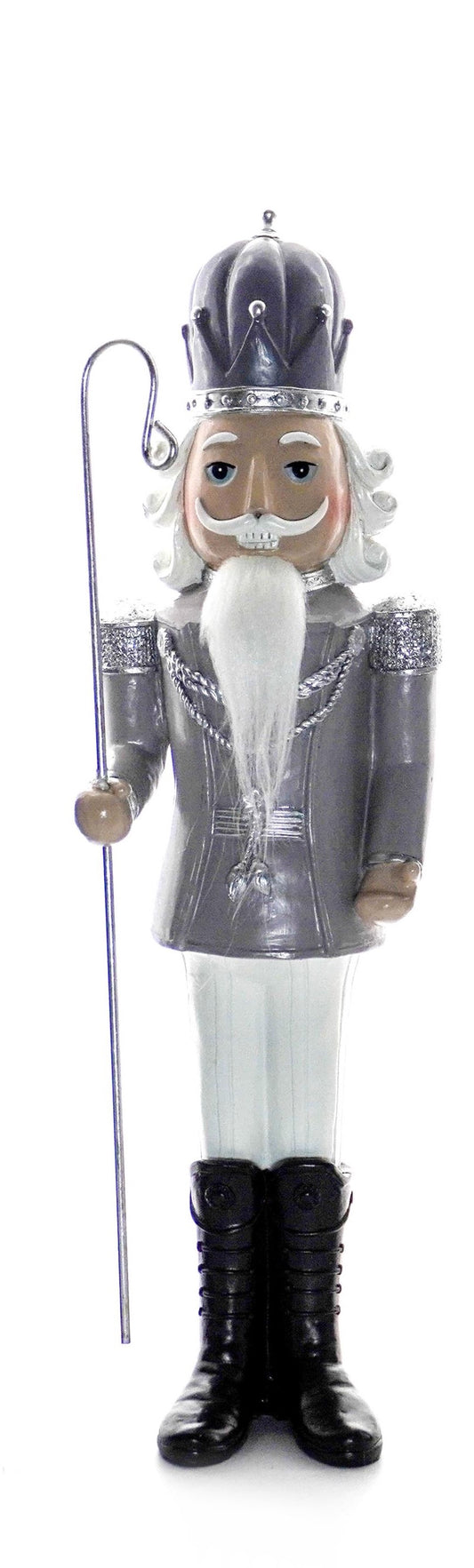 Silver nutcracker soldier holding a trumpet, wearing silver jacket and tall black boots