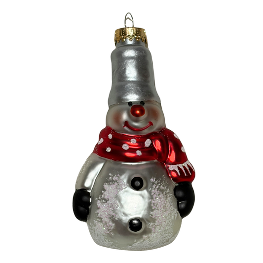 Glass snowman ornament with a silver body, red scarf, and black buttons on a white background