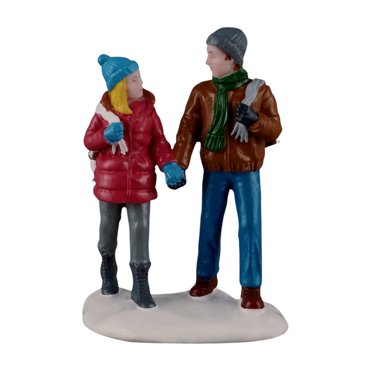 Christmas village figurine of a couple holding hands in winter coats and beanies, the woman in red and the man in brown
