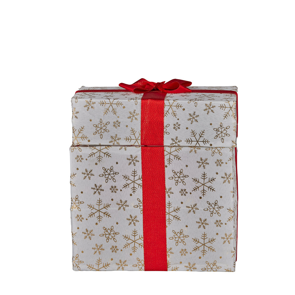 White and gold snowflake gift box decoration with red ribbon and bow, unlit

