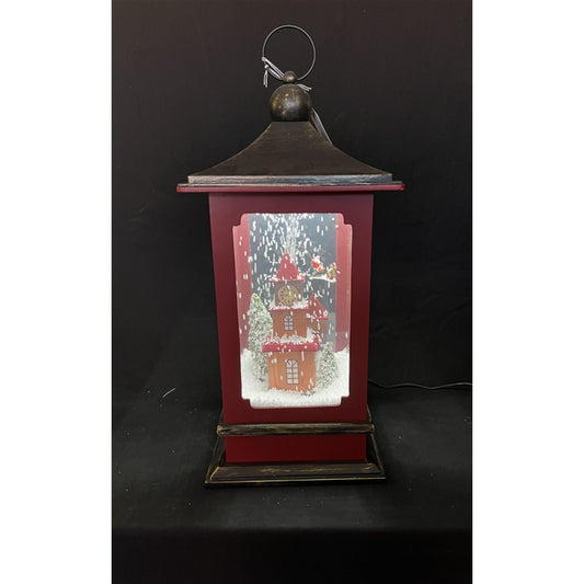 Red lantern featuring a light-up gingerbread house scene with swirling snow and LED illumination