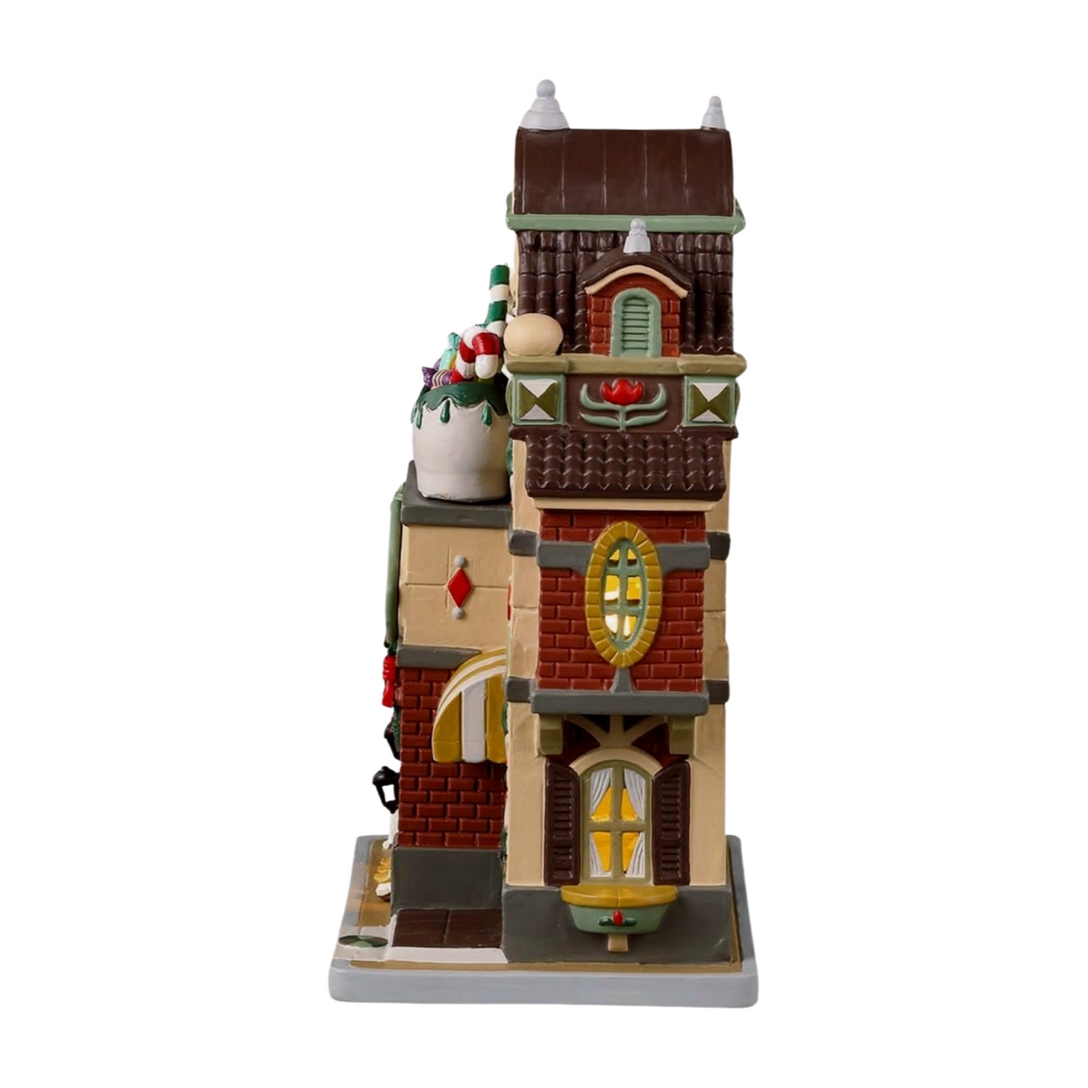Rear view of St. Nick's Wooden Shoe Shop Christmas village building with illuminated windows, brick facade, and small white dog figurine