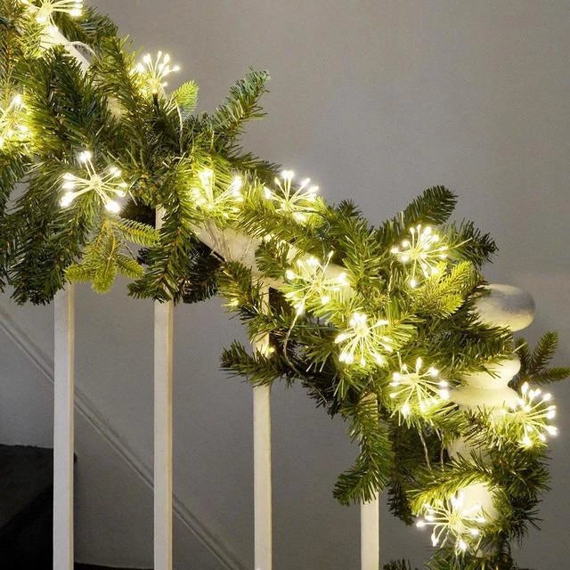 Close-up of a warm white LED starburst fairy light cluster against a dark background