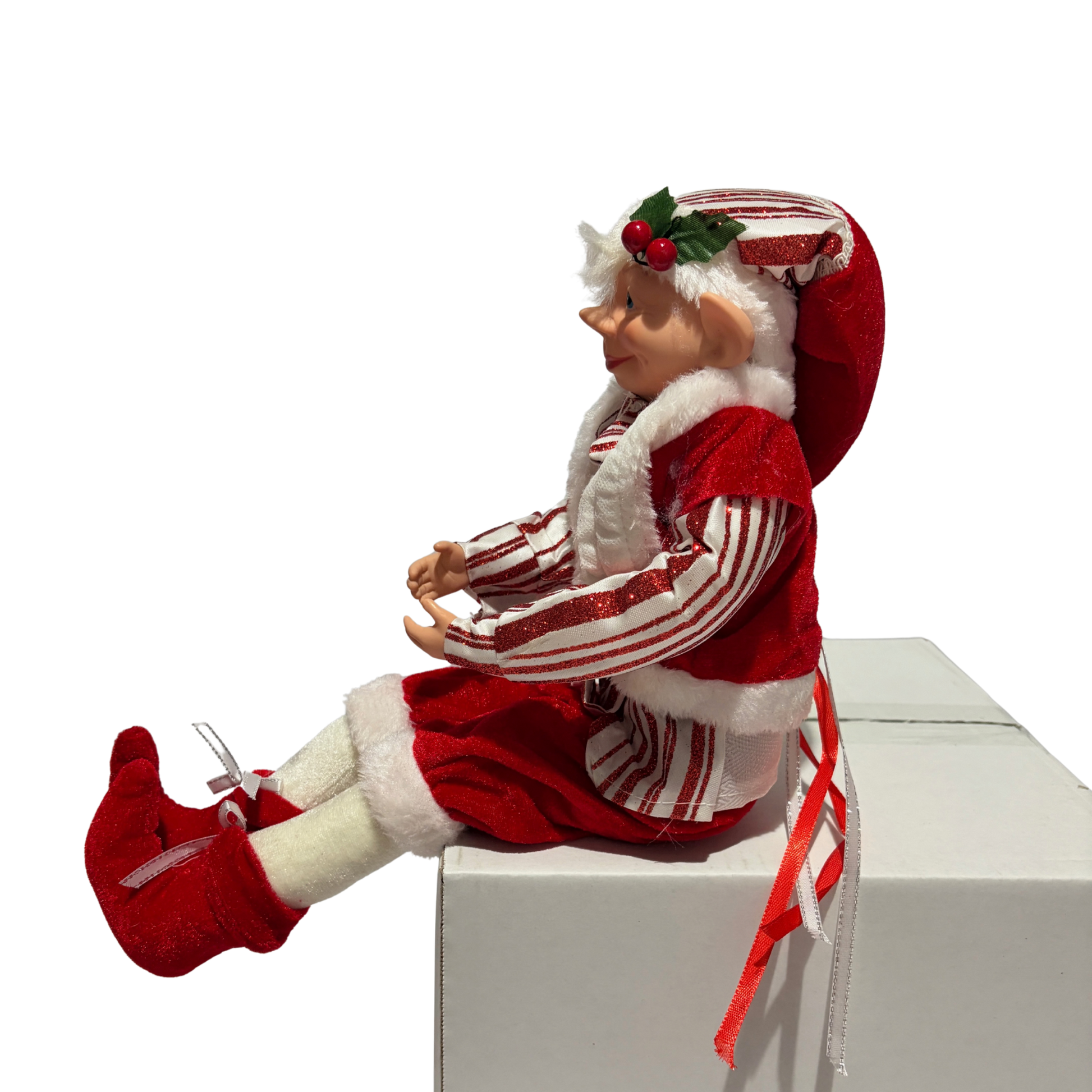 Sitting Christmas elf in red-and-white striped jacket and hat with white trim and red boots