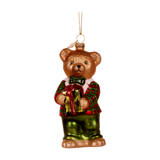 Glass teddy bear decoration wearing a red and green outfit and holding a wrapped gift with a red ribbon