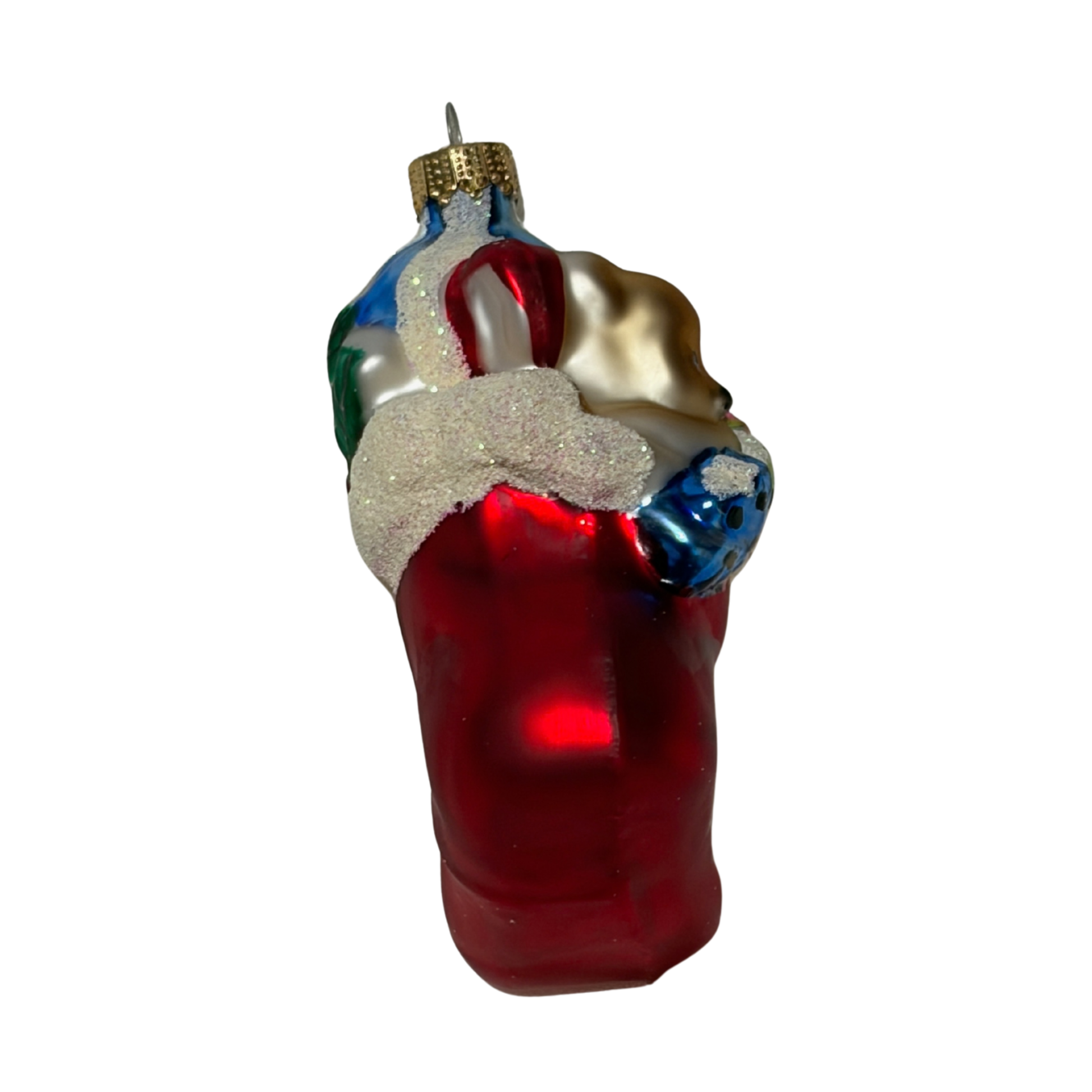 Teddy bear Christmas tree decoration sitting in a red stocking and holding a festive bouquet