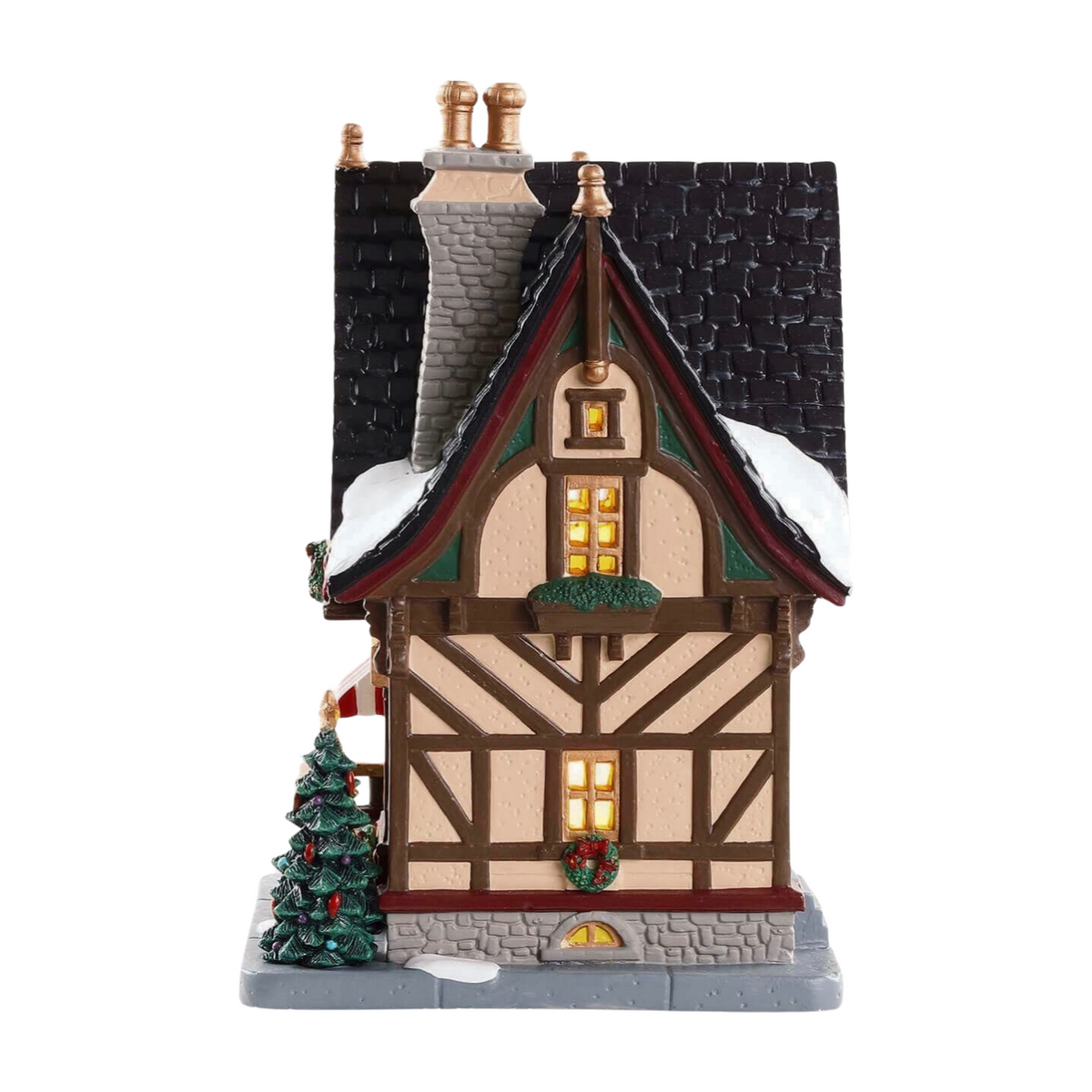 Left view of Lemax Christmas Cubby village building showing Tudor-style exterior, lit windows, dark tiled roof, and Christmas tree 