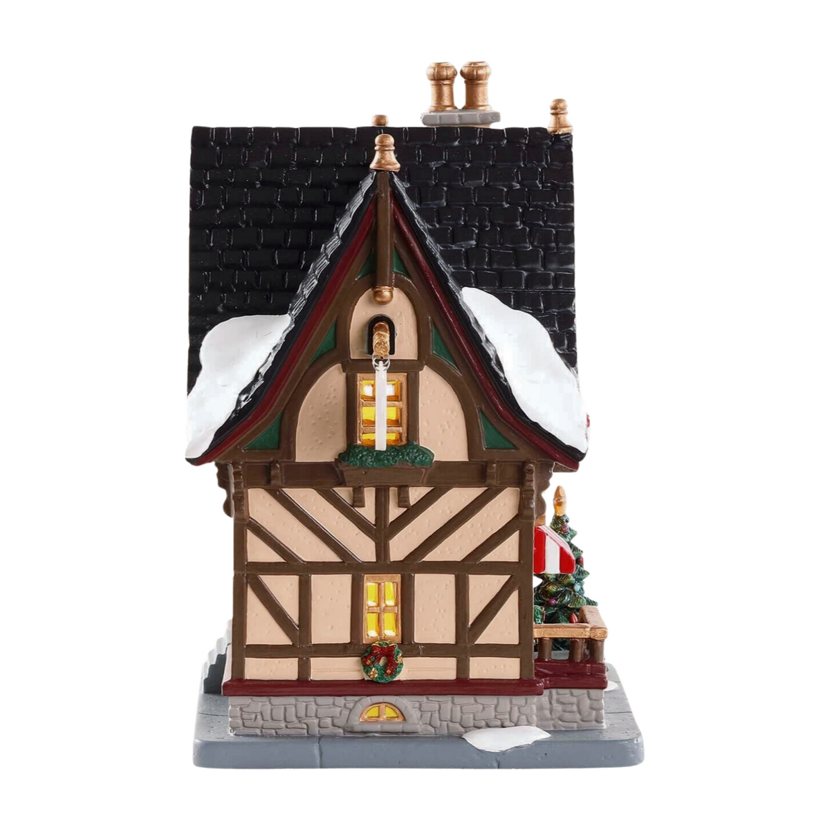 Right view of Lemax Christmas Cubby village building with Tudor exterior, two lit windows, dark tiled roof, and striped awning