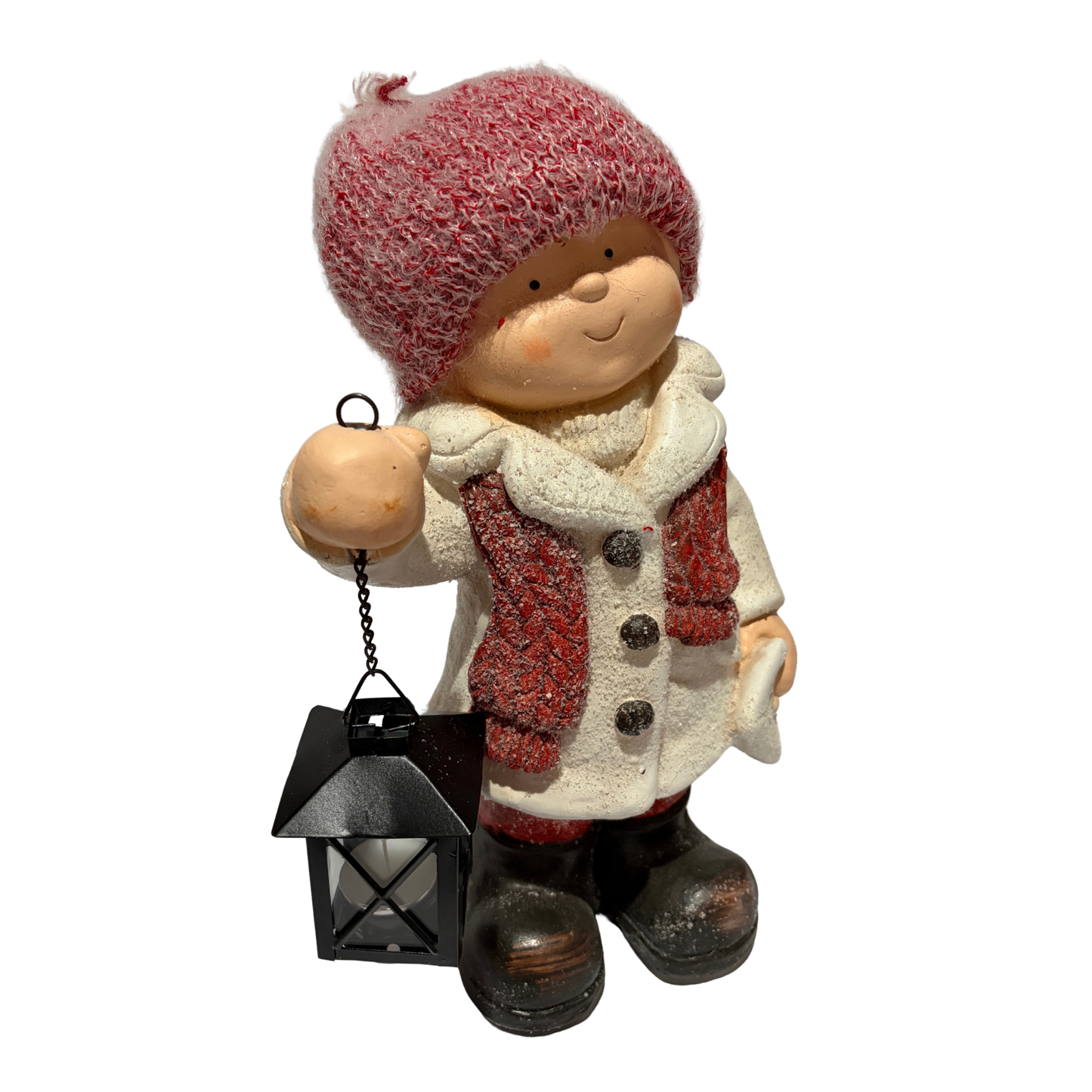 Winter boy figurine in a white coat and red hat holding a black lantern
