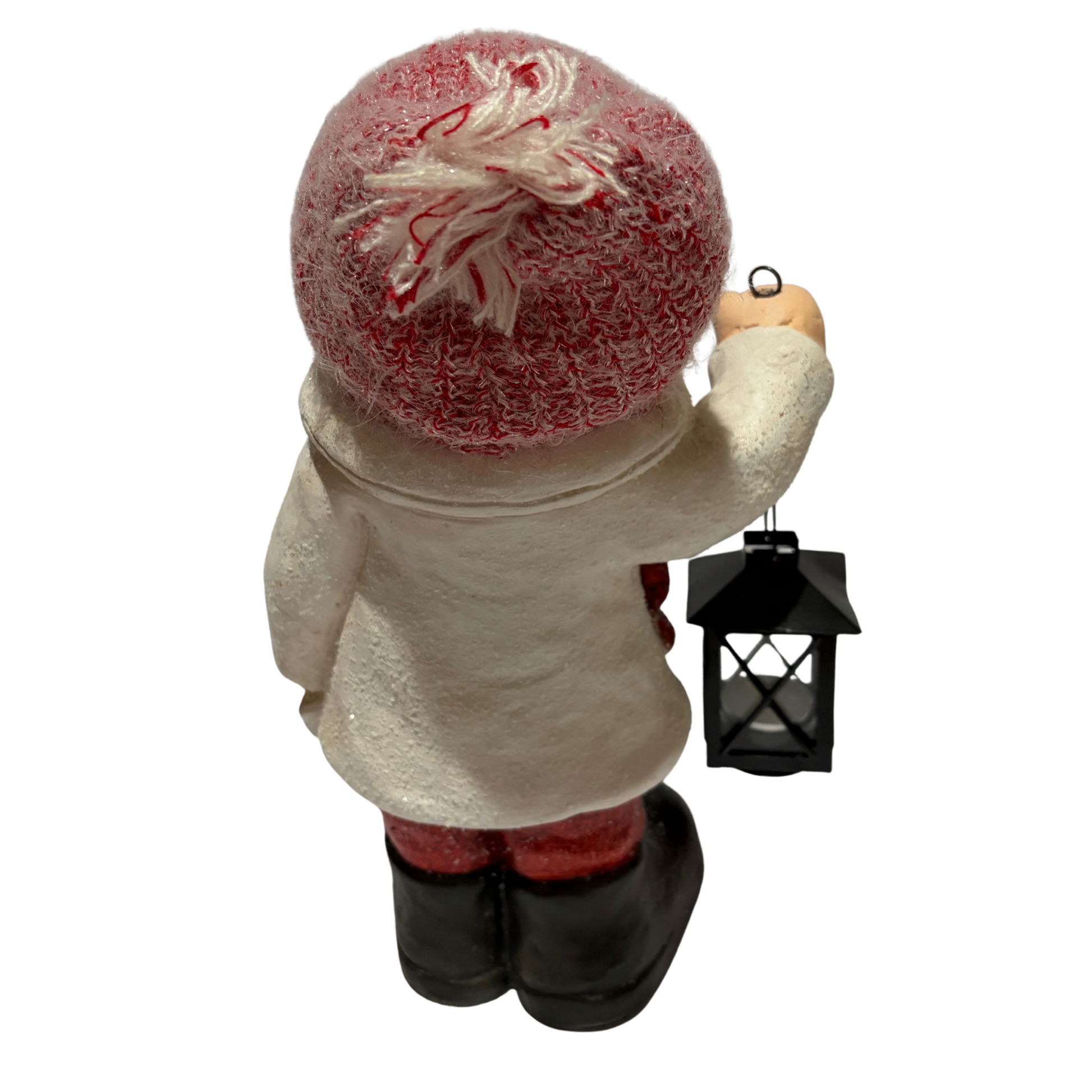 Winter boy figurine in a white coat and red hat holding a black lantern