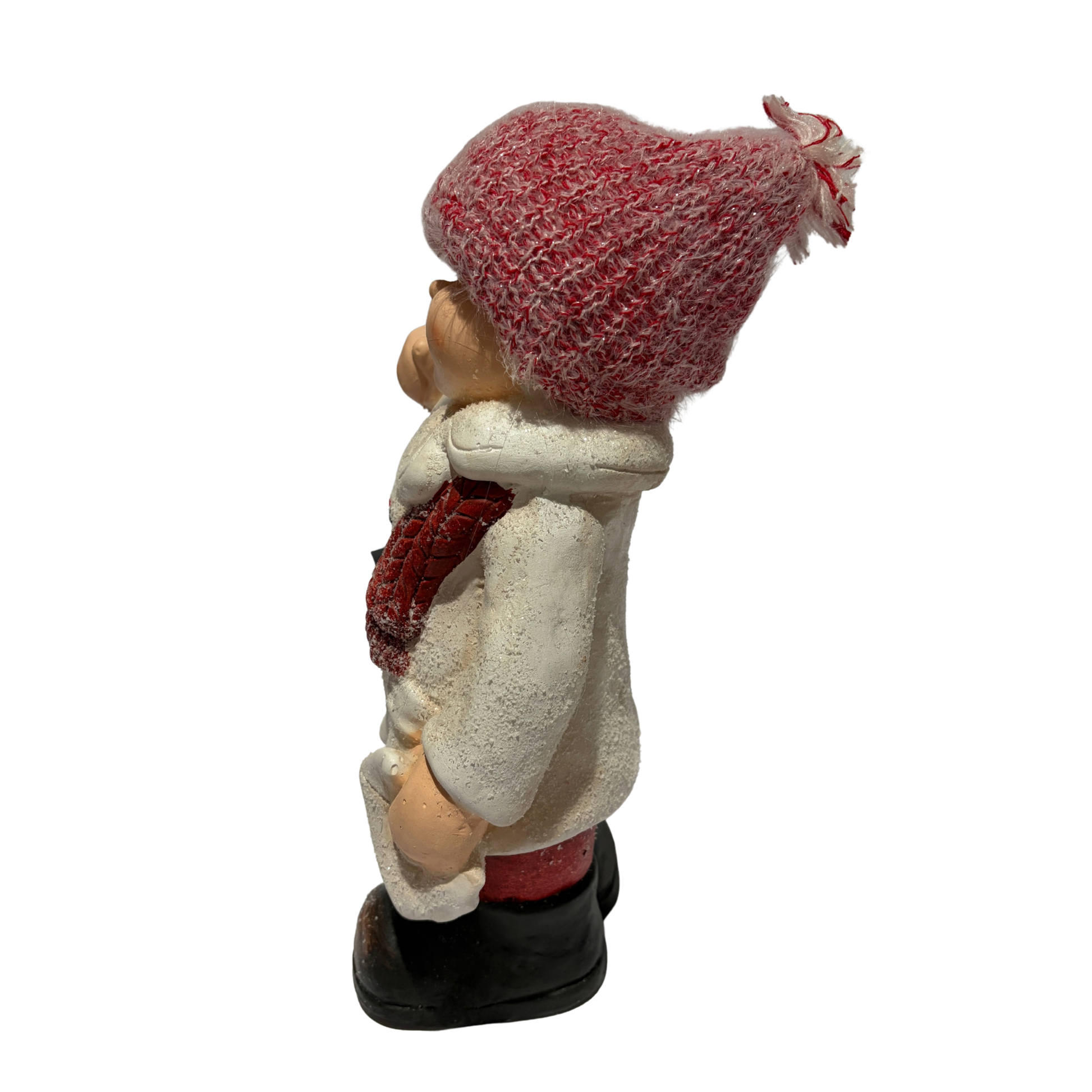 Winter boy figurine in a white coat and red hat holding a black lantern