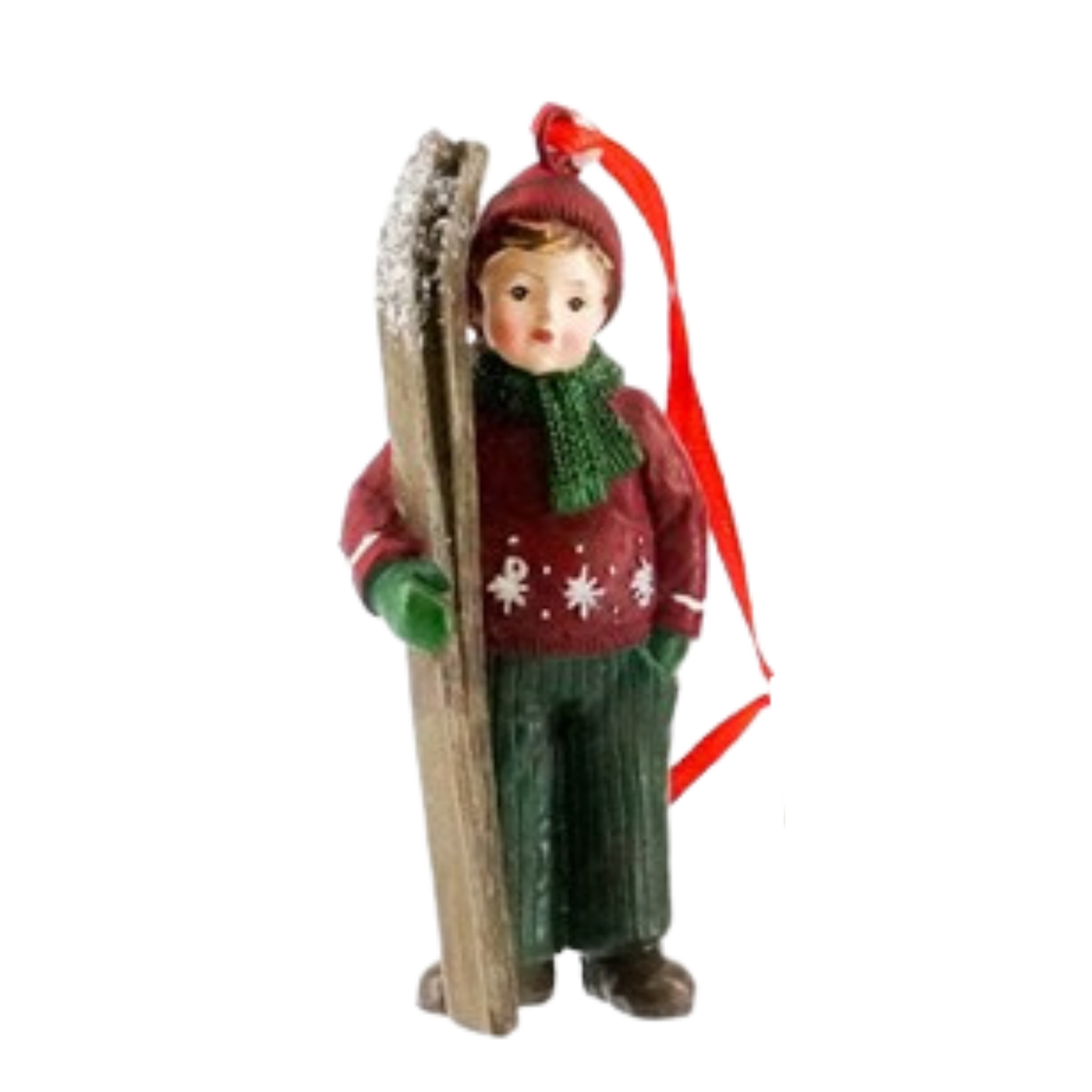Christmas tree decoration of a boy in a red snowflake jumper and green scarf carrying a pair of snow-dusted skis