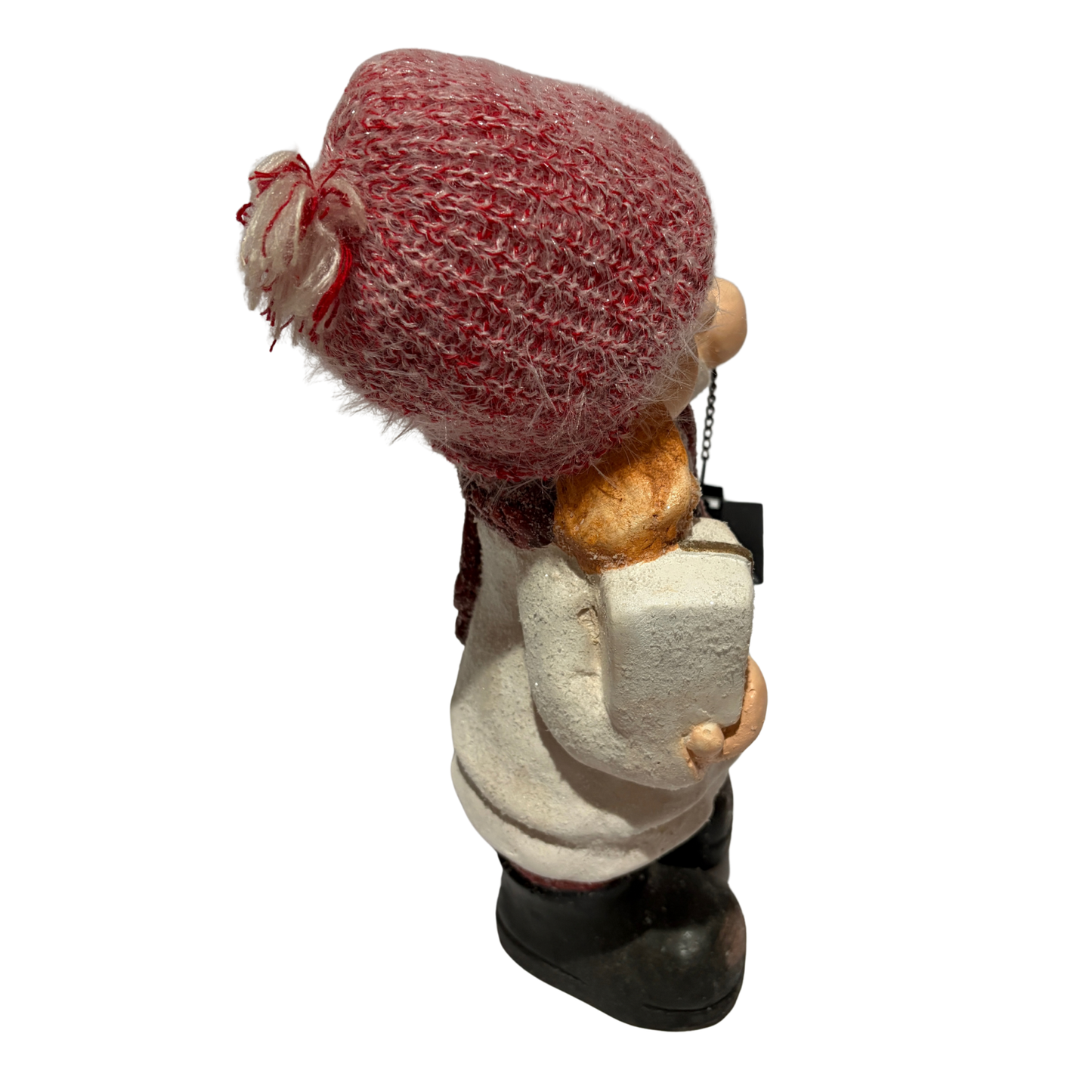 Winter girl figurine in a white coat and red hat holding a black lantern