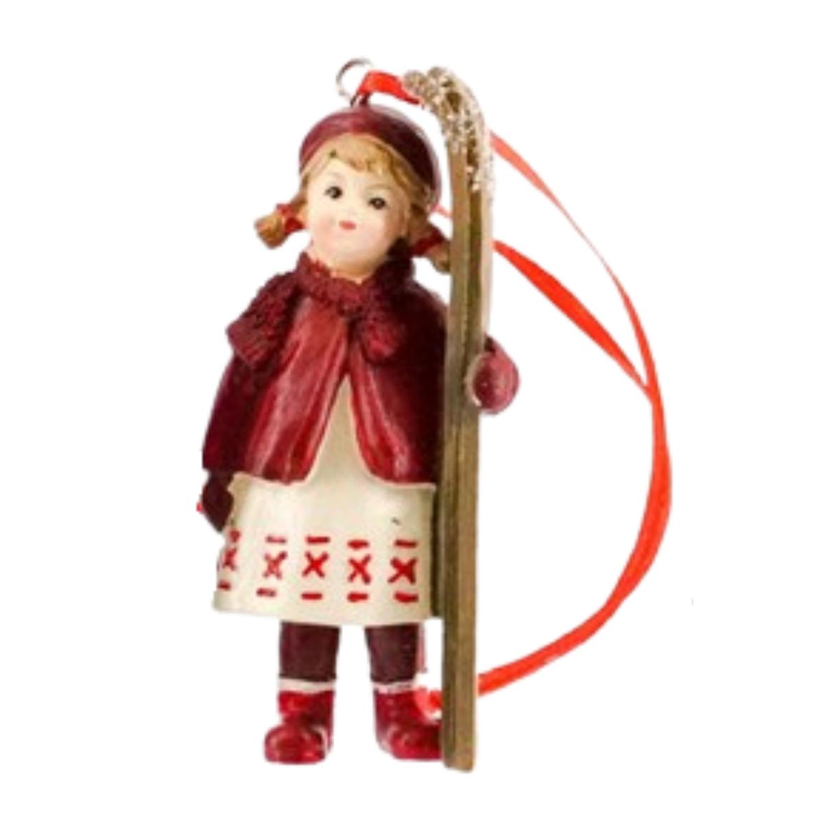 Christmas tree decoration of a girl in a red cape and patterned skirt standing beside a pair of skis