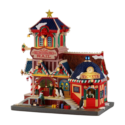 Lit Everlasting Christmas Trees factory village scene with flocking station, glass dome, worker figurines, red truck, and tree display signage