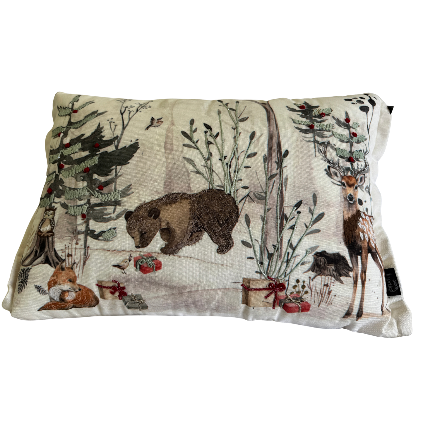 Cushion with embroidered woodland Christmas scene featuring bear, deer, and fox